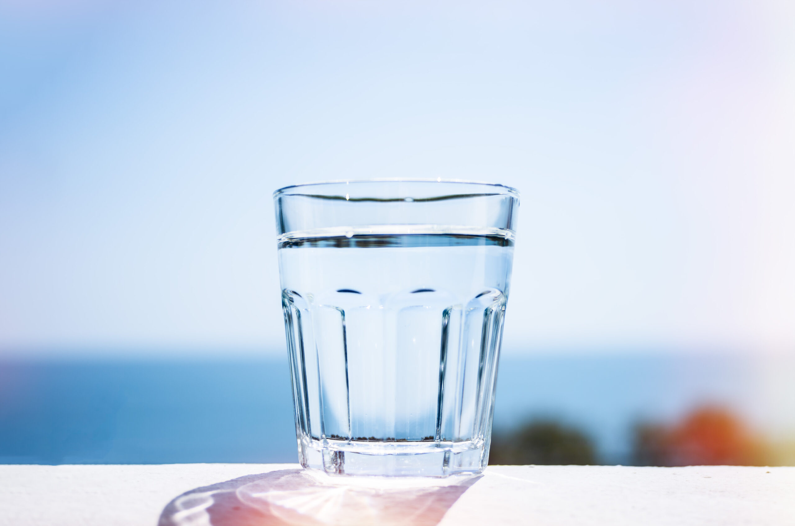 Clean water in a glass. Marine background. The concept of a healthy lifestyle.
